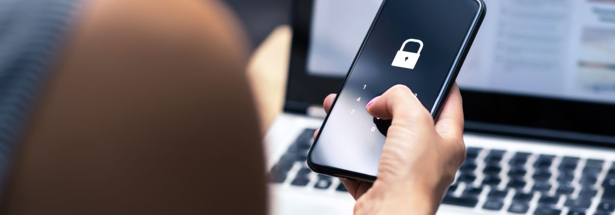 Person holding phone with locked icon symbolising security. 